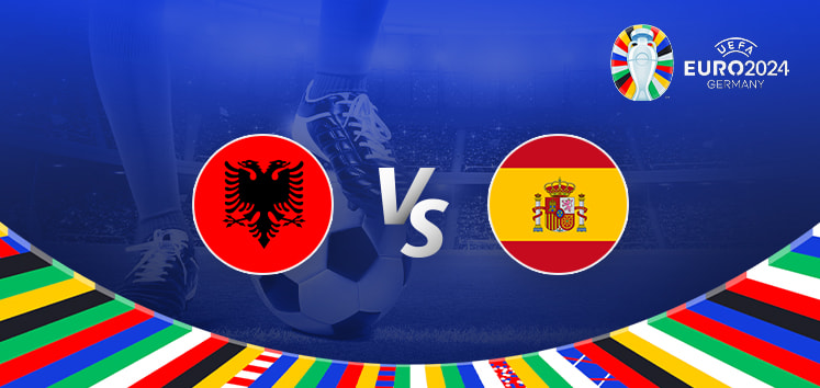 A promotional graphic for the Euro 2024 football match between Albania and Spain. The image features the national flags of Albania (a red flag with a black double-headed eagle) and Spain (a red and yellow horizontal bicolor with the national coat of arms) positioned on either side of a large "Vs" in the center. The background shows a football stadium under bright lights with a close-up of a player's leg and a football. The Euro 2024 logo and the word "Germany" are displayed in the top right corner, while a colorful border with various national flags decorates the bottom edge.