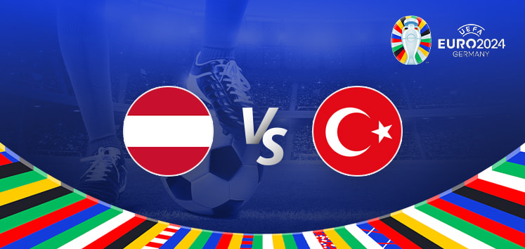 The promotional graphic for the Euro 2024 football match between Austria and Türkiye features a dynamic and vibrant design. At the center of the image, there are two roundels with the national flags: Austria's flag (a red and white horizontal bicolor) on the left and Türkiye's flag (a red field with a white star and crescent) on the right, separated by a large "Vs" in white text, symbolizing the upcoming clash. The background showcases a football stadium under the evening lights, creating an intense and electrifying atmosphere. Below the central elements, a colorful arc composed of various national flags represents the international spirit of the Euro 2024 tournament. The Euro 2024 logo is prominently displayed at the top right, featuring the tournament branding and host country, Germany. The overall composition uses light and shadow to create depth, emphasizing the central matchup between Austria and Türkiye.
