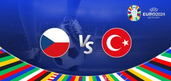 The image is a promotional graphic for the Euro 2024 football match between Czech Republic and Turkey. It prominently features the national flags of the Czech Republic on the left and Turkey on the right, with a large "Vs" in the center indicating the matchup. In the background, there is a football stadium illuminated under bright lights, creating an energetic and vibrant atmosphere. The Euro 2024 logo is displayed in the top right corner, emphasizing the branding of the tournament. The bottom of the image is decorated with a colorful border showcasing various national flags, adding to the festive and international spirit of the event. A close-up of a player's legs and a football is visible in the background, symbolizing the competitive nature of the upcoming match.