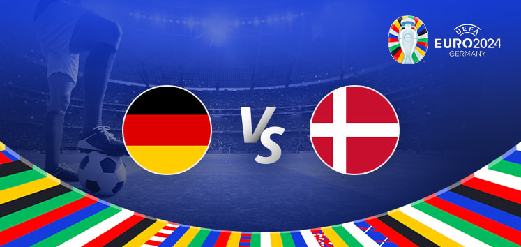 This image is a promotional graphic for the Euro 2024 football match between Germany and Denmark. It features a vibrant and dynamic design that captures the excitement of the event. The central part of the image shows two large, circular national flags representing Germany (black, red, and yellow) on the left and Denmark (red and white) on the right, separated by a "Vs" in white text, indicating the matchup. Below the flags and text is a stylized, colorful arc composed of multiple national flags, reflecting the international nature of the tournament. The background depicts a large, packed stadium filled with blue tones and spotlights that enhance the sense of a major sporting event. In the foreground, a close-up of a player's foot on a football, poised to kick, adds a sense of immediacy and action. The Euro 2024 logo is subtly integrated at the top right, further branding the event. The overall composition uses light and shadow to create depth, focusing attention on the central clash between Germany and Denmark.