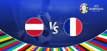 The image is a promotional graphic for the Euro 2024 football match between Austria and France. It features the national flags of Austria (a horizontal bicolour of red and white) and France (a vertical tricolour of blue, white, and red) positioned on either side of the letters "Vs" in the centre. The background shows a football stadium under bright lights, with a close-up of a player's leg and a football in the centre. The top right corner displays the Euro 2024 logo along with the tournament name and location, "Germany." The bottom edge is adorned with a colourful border featuring various national flags.