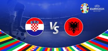 The image is a promotional graphic for the Euro 2024 football match between Croatia and Albania. It features the national flags of Croatia (a red, white, and blue flag with a checkerboard coat of arms) and Albania (a red flag with a black double-headed eagle) positioned on either side of the letters "Vs" in the centre. The background shows a football stadium under bright lights, with a close-up of a player's leg and a football on the left side. The top right corner displays the Euro 2024 logo along with the tournament name and location, "Germany." The bottom edge is adorned with a colourful border featuring various national flags.