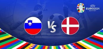 The image depicts a graphic for the Euro 2024 football match between Slovenia and Denmark. It features the national flags of Slovenia and Denmark positioned on either side of the letters "Vs" at the centre. In the background, there is a blurred stadium scene with a football at a player's feet, emphasizing the competitive nature of the match. The top right corner displays the Euro 2024 logo with the tournament name and location, "Germany." The bottom of the image is bordered by a colourful array of national flags from various countries, adding a vibrant and festive touch.