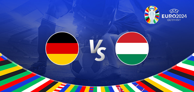 The image is a promotional graphic for the Euro 2024 football match between Germany and Hungary. It features the national flags of Germany (a black, red, and gold flag) and Hungary (a red, white, and green flag) positioned on either side of the letters "Vs" in the centre. The background shows a football stadium under bright lights, with a close-up of a player's leg and a football on the left side. The top right corner displays the Euro 2024 logo along with the tournament name and location, "Germany." The bottom edge is adorned with a colourful border featuring various national flags.