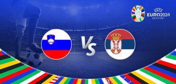 The image is a promotional graphic for the Euro 2024 football match between Slovenia and Serbia. It features the national flags of Slovenia (a blue, white, and red horizontal tricolour with the country's coat of arms in the upper left corner) and Serbia (a red, blue, and white horizontal tricolour with the country's coat of arms in the center). The flags are positioned on either side of a large "Vs" in the center. The background depicts a football stadium under bright lights, with a close-up of a player's leg and a football in the bottom left corner. The top right corner displays the Euro 2024 logo along with the tournament name and location, "Germany." The bottom edge is adorned with a colourful border featuring various national flags.