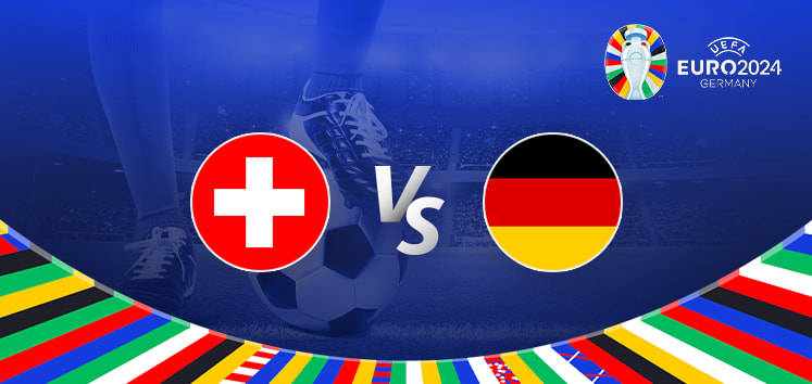 Promotional graphic for the Euro 2024 football match between Switzerland and Germany. The image features the national flags of Switzerland (a white cross on a red background) and Germany (a horizontal tricolour of black, red, and gold) positioned on either side of a large "Vs" in the center. The background displays a football stadium under bright lights with a close-up of a player's leg and a football. The Euro 2024 logo and "Germany" are shown in the top right corner, while a colorful border with various national flags decorates the bottom edge.