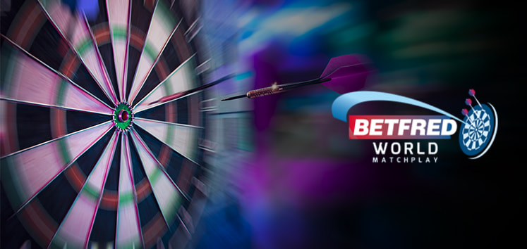 The image features a dartboard in the background with a dart in mid-flight, appearing to have been thrown towards the board. The left side of the image showcases the dartboard, with the numbers and segments clearly visible, while the dart is captured in sharp focus against a blurred background, emphasising motion and action. On the right side, the logo for the Betfred World Matchplay is prominently displayed, including the Betfred branding and a stylised dartboard graphic. The overall composition suggests dynamic movement and excitement, highlighting the competitive nature of the World Matchplay Darts event.