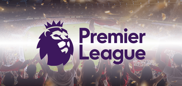 Premier League logo displayed over a football stadium filled with cheering fans under bright lights, capturing the excitement of a live matchday atmosphere.