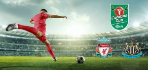 A football player in a red kit taking a shot on goal in a large stadium, with the Carabao Cup logo and the emblems of Liverpool FC and Newcastle United in the background, symbolising their upcoming match in the tournament.